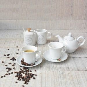 Coffee set with milk, or infusion of White Ceramic six dishes and cups. Finely decorated with motifs and soft floral.